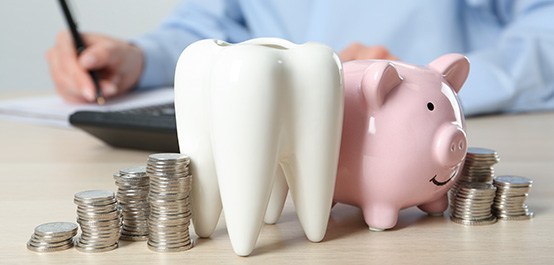 Coins next to a piggy bank