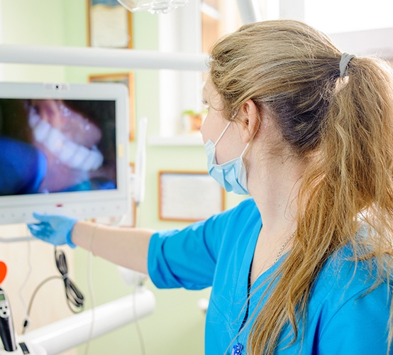Dental team member looking at intraoral images on computer screen