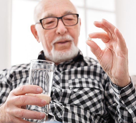 Man holding oral conscious dental sedation pill