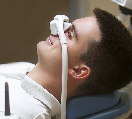 Man with nitrous oxide dental sedation mask in place