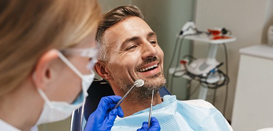 Man in dental chair about to undergo examination
