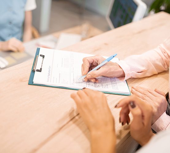 Patient completing dental insurance forms