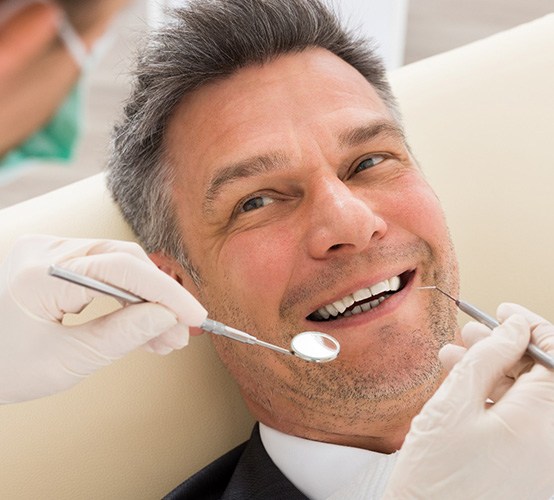 Man smiling at dentist in Owasso