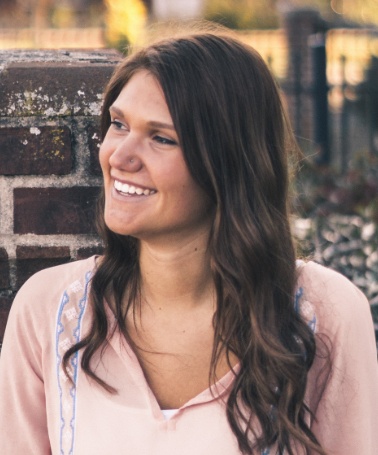 Young woman in pink blouse smiling