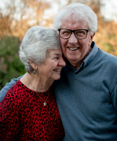 Senior man and woman smiling outdoors