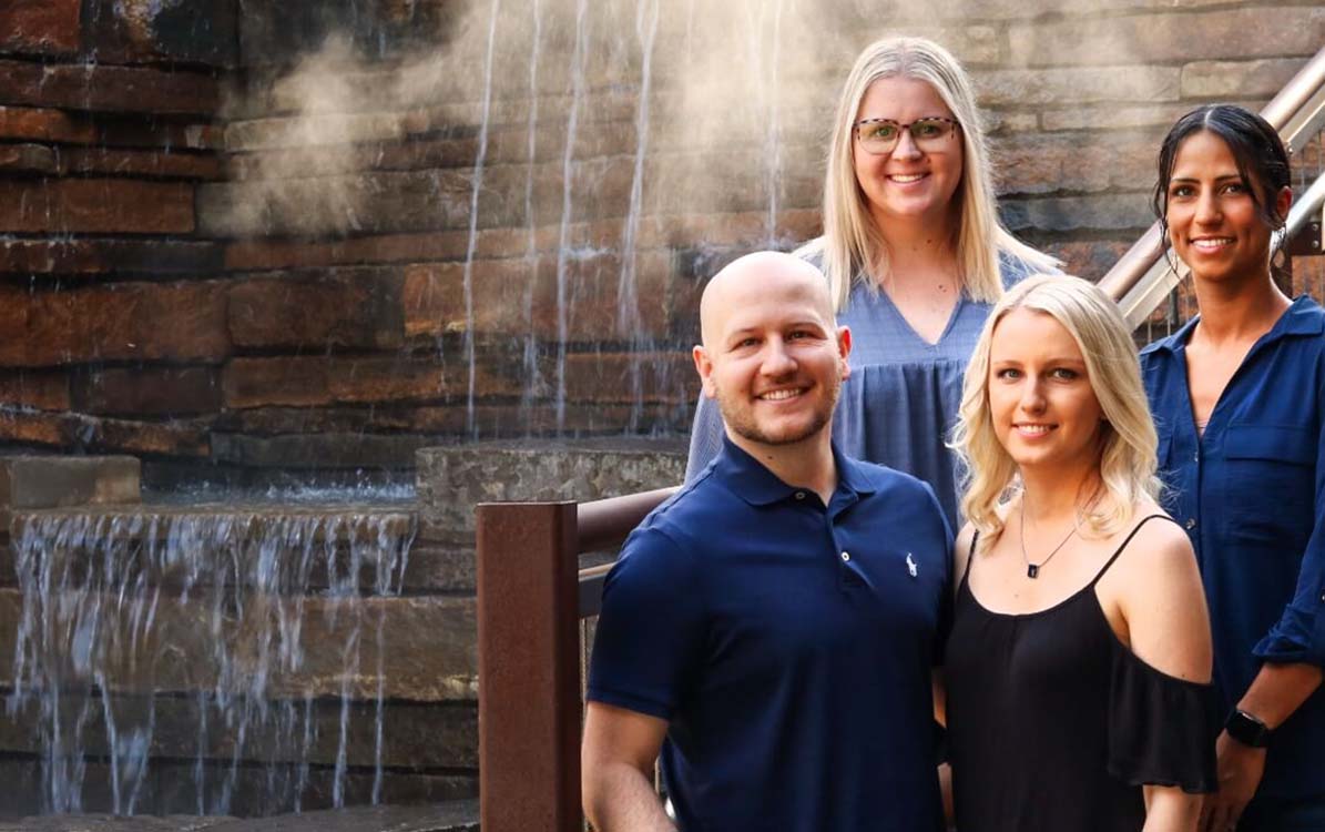 Owasso dentist and dental team members smiling outdoors