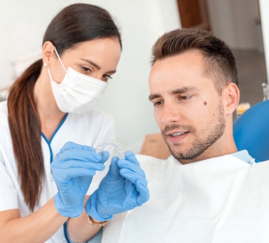 dentist explaining Invisalign to patient