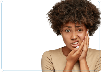woman holding mouth in pain