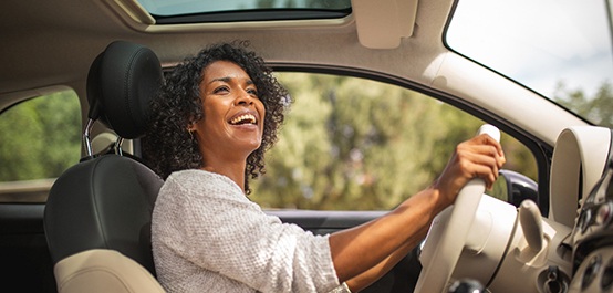 Woman smiling while driving