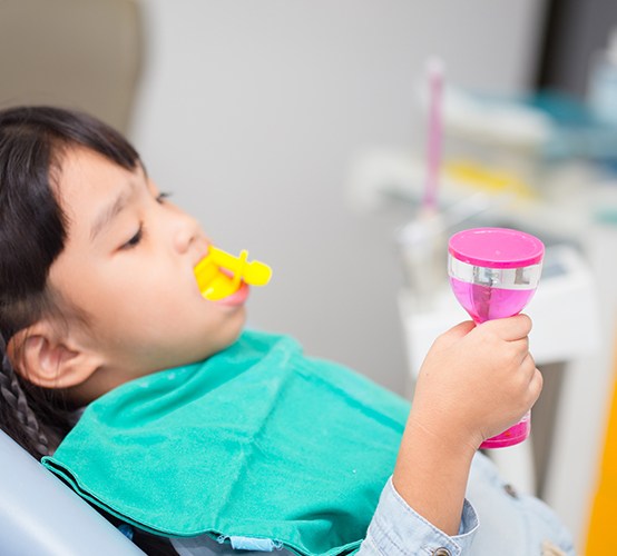 Child receiving fluoride treatment