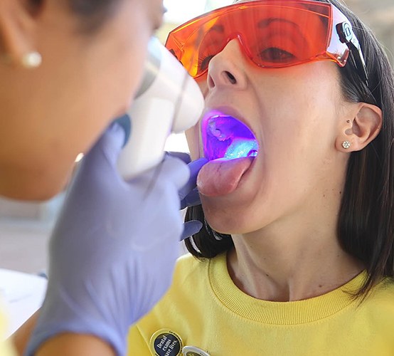 Dentist performing oral cancer screening