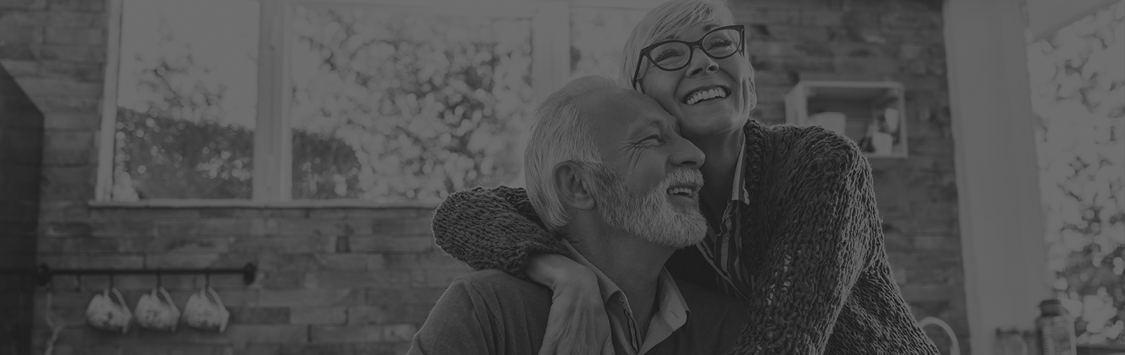 Older couple smiling together after restorative dentistry