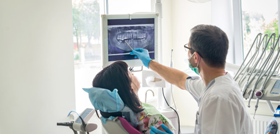 a dentist showing a patient her X-rays