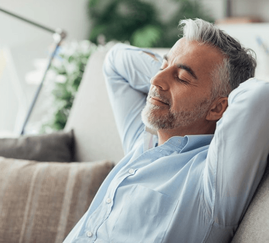 a man resting after undergoing wisdom teeth extractions