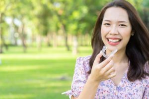 Woman holding her Invisalign tray.