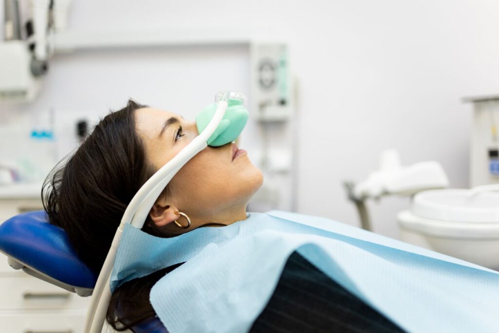 A woman getting nitrous oxide during a dental treatment.